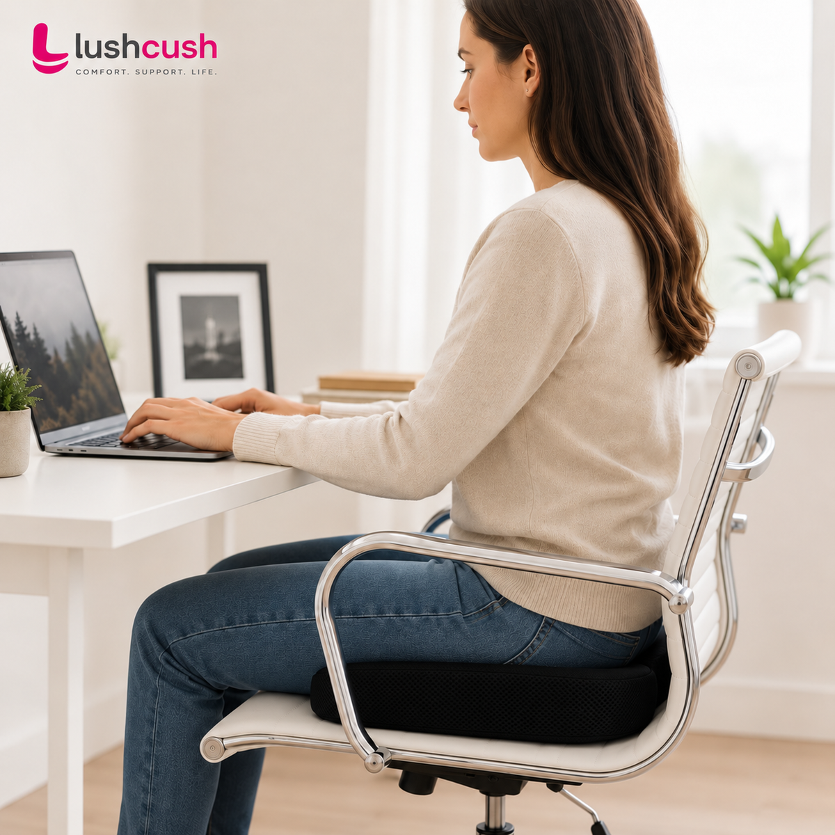 Woman using LushCush ergonomic coccyx cushion on office chair for comfortable sitting and posture support